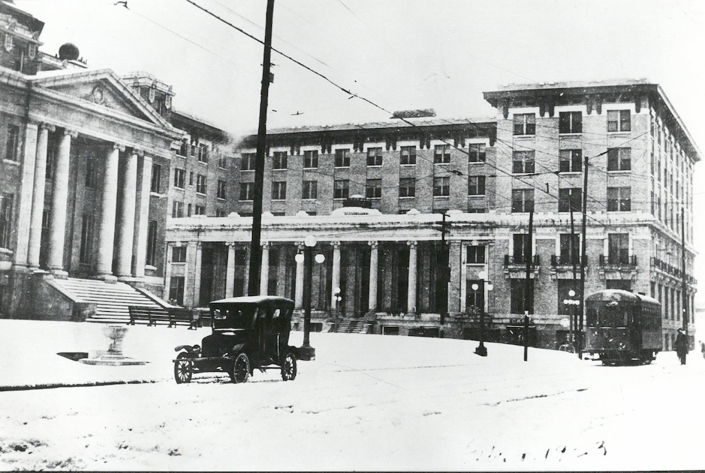 Snowy day in 1923 in downtown Alexandria, Louisiana, with the Hotel Bentley, City Hall and a streetcar on Second Street.
